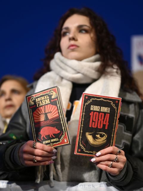 A woman holds books as thousands gather to oppose the policies of Slovakia’s Prime Minister Robert Fico in Bratislava, Slovakia (Denes Erdos/AP)