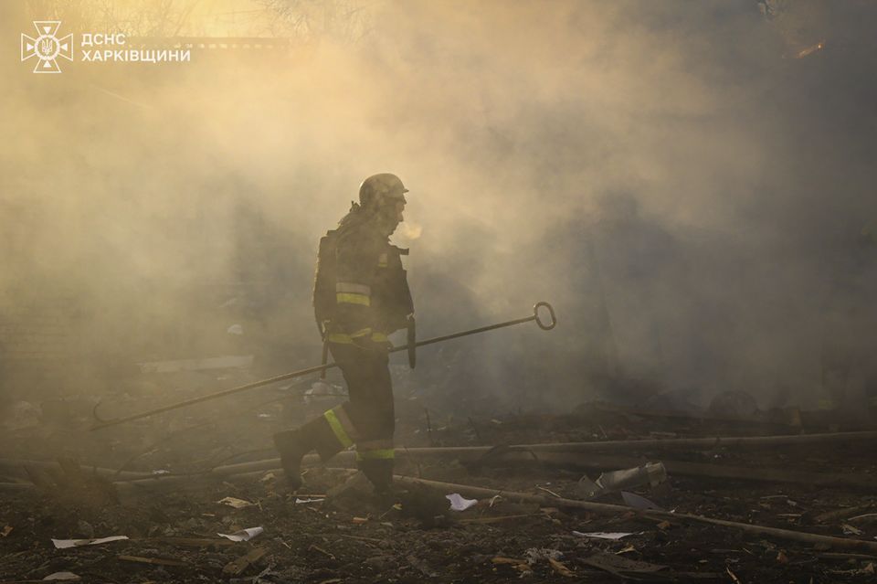 A firefighter works to extinguish the fire following a Russian rocket attack in Kharkiv (Ukrainian Emergency Service via AP)