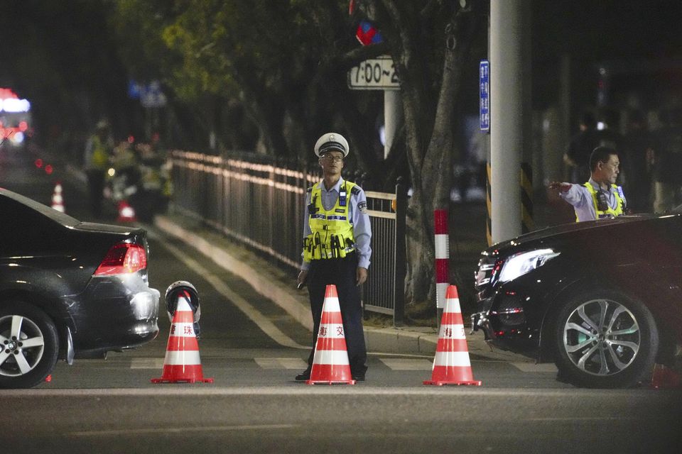 A security guard stands near the sports centre in Zhuhai, where the incident took place (Kyodo News/AP)