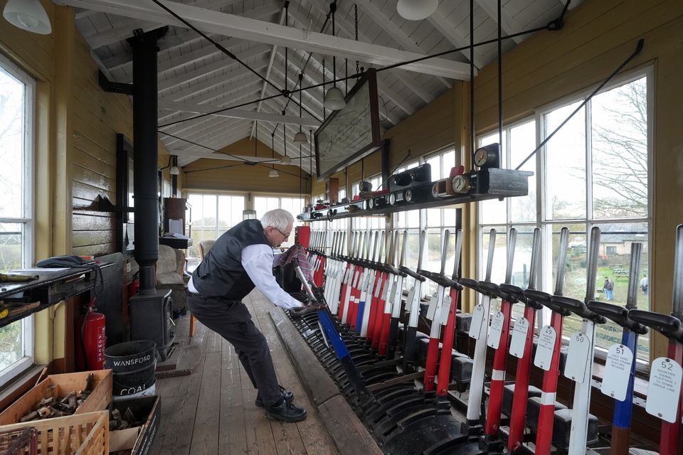 A signaller at work in the signal box at Wansford station (Joe Giddens/PA)