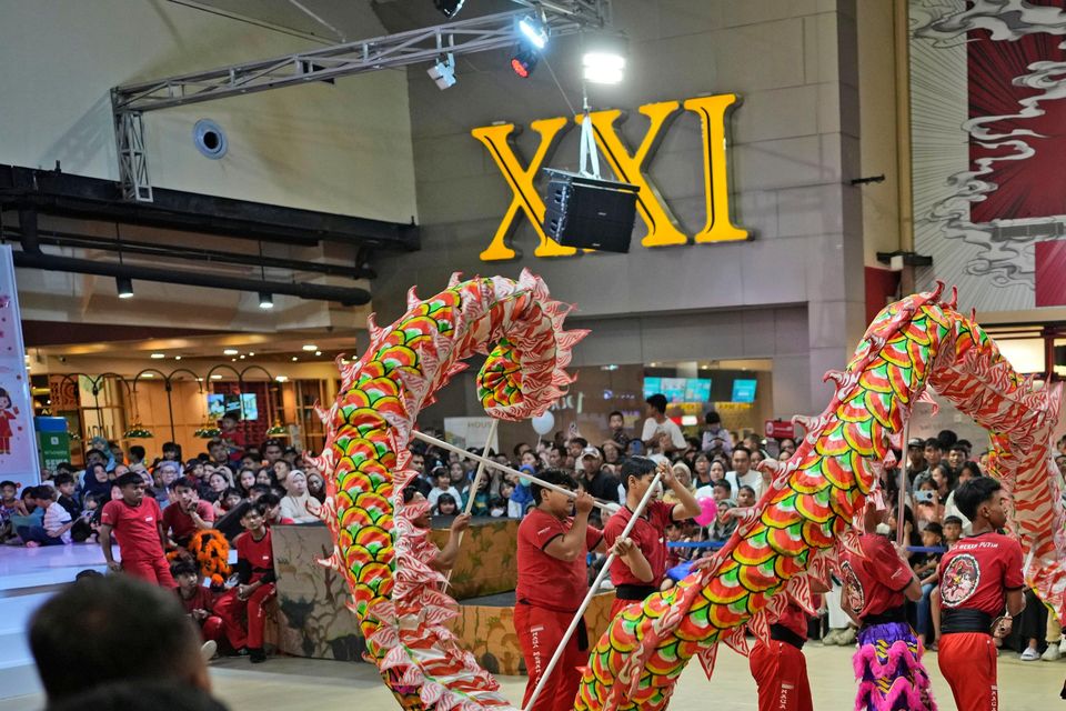 Dance club Naga Merah Putih put on a performance in a shopping centre (Dita Alangkara/AP)