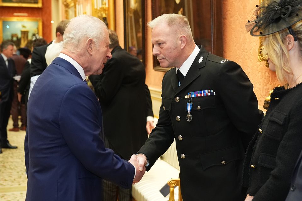 Constable Zachary Printer, Devon and Cornwall Police, shakes hands with the King as he receives the King’s Gallantry Medal (Aaron Chown/PA)