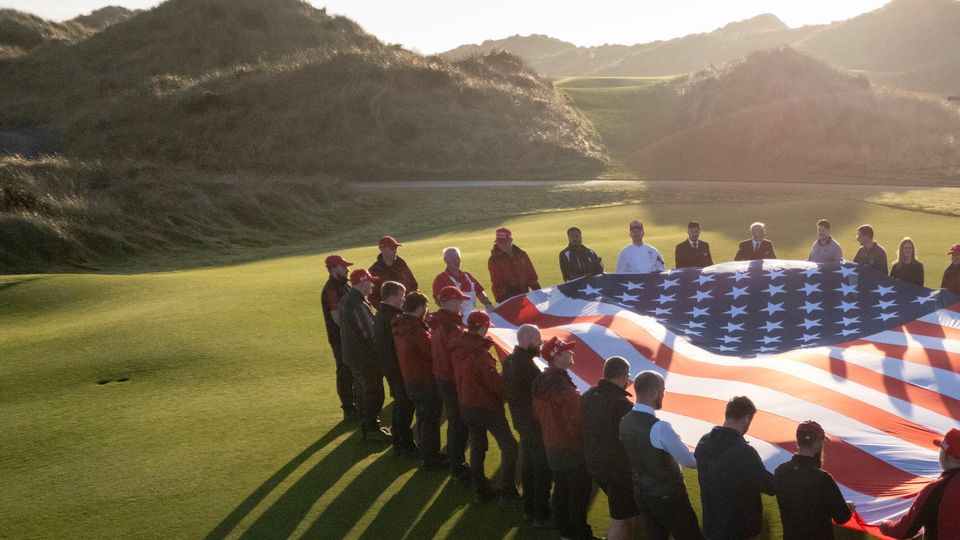 Trump International Scotland staff hold the American flag in celebration of Donald Trump’s election victory (Derek Ironside at Newsline Media/PA)