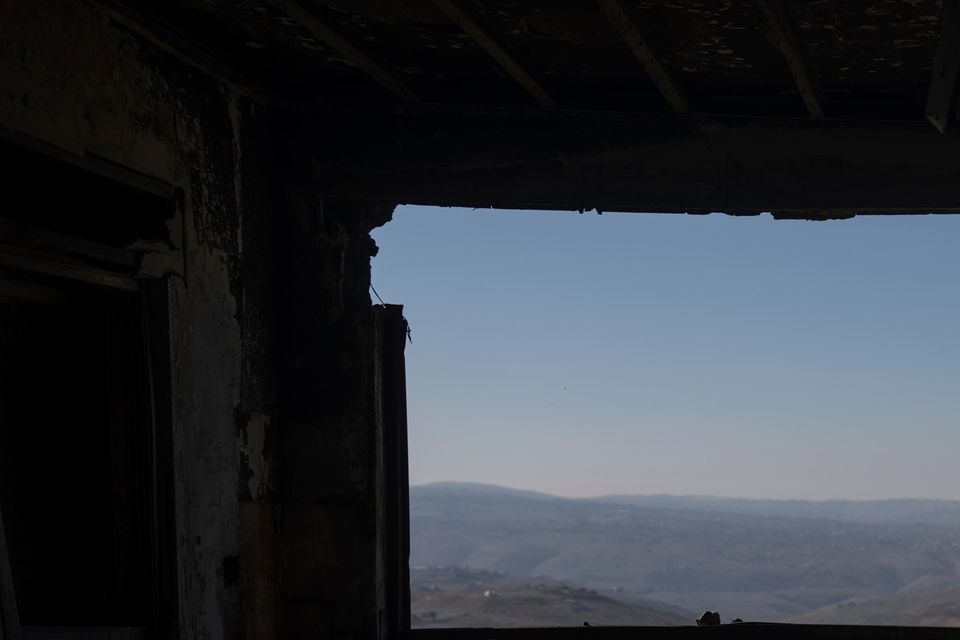 A view of a Lebanese village through the window of a house in Kibbutz Manara damaged by a rocket fired from Lebanon (Ohad Zwigenberg/AP)