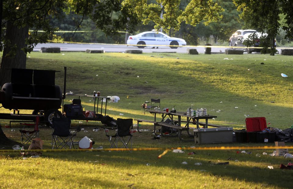 Debris is strewn about as police tape seals off an area of Maplewood Park, Rochester, New York (Tina MacIntyre-Yee/AP)