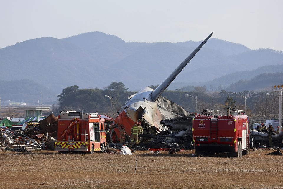 Firefighters and rescue team members work at the scene of the fire (Cho Nam-soo/Yonhap/AP)