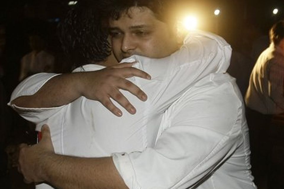 ** ALTERNATE CROP ** Employees of The Taj Hotel comfort each other after they were rescued from the hotel in Mumbai, India, Thursday, Nov. 27, 2008. (AP Photo/Gautam Singh)