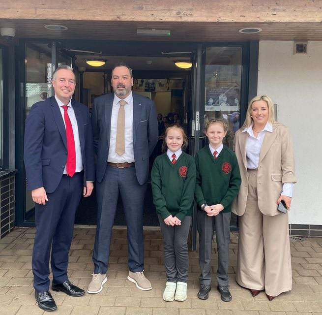 Paul Givan was greeted by Bunscoil Phobal Feirste principal, Séamus Ó Tuama, pupils from the school council and Sinn Fein MLA Órlaithí Flynn after the bell rang on Wednesday.