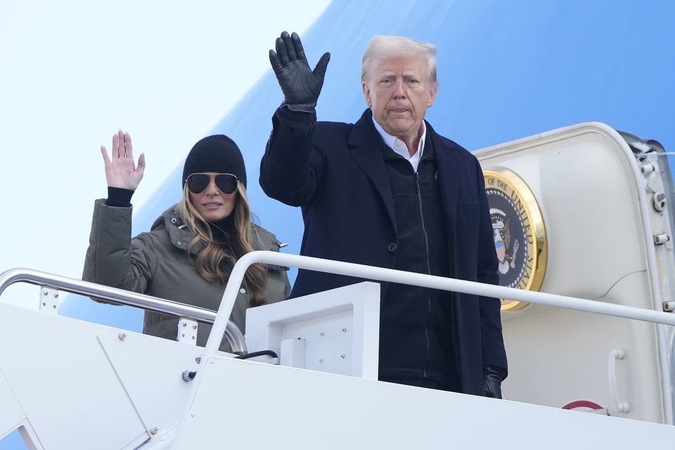 President Donald Trump and first lady Melania Trump wave as they board Air Force One (Mark Schiefelbein/AP)