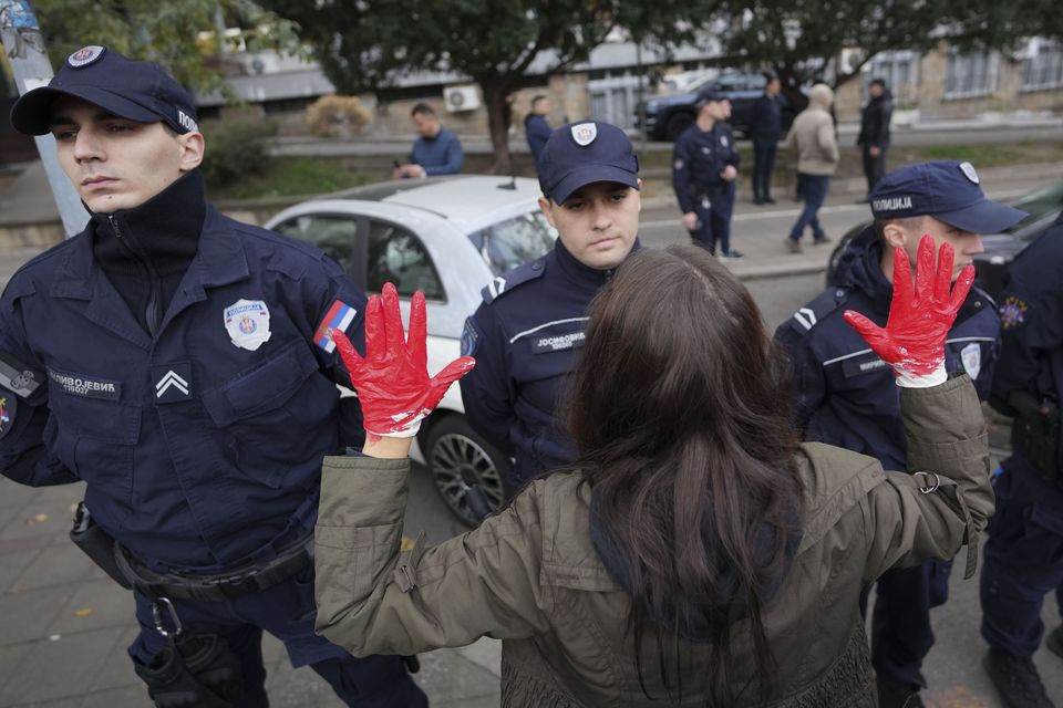 Protesters in Belgrade, with red paint on their hands to symbolise blood, shout slogans and demand arrests after the station disaster in Novi Sad on Friday (Darko Vojinovic/AP)