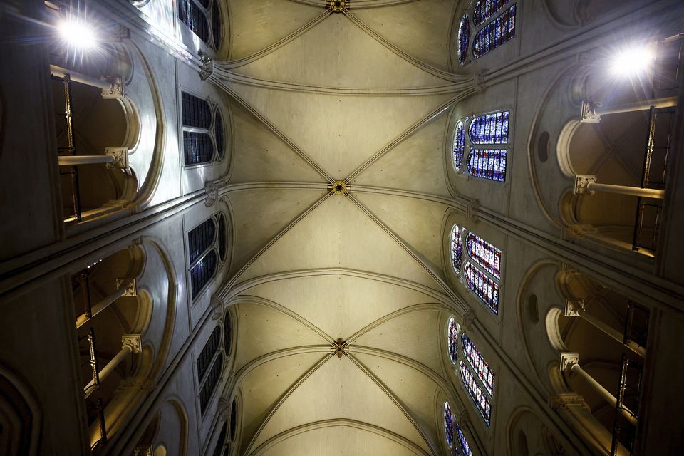 Gaping holes left in the vaulted ceilings and charred piles of debris are now gone. (Sarah Meyssonnier, pool via AP)