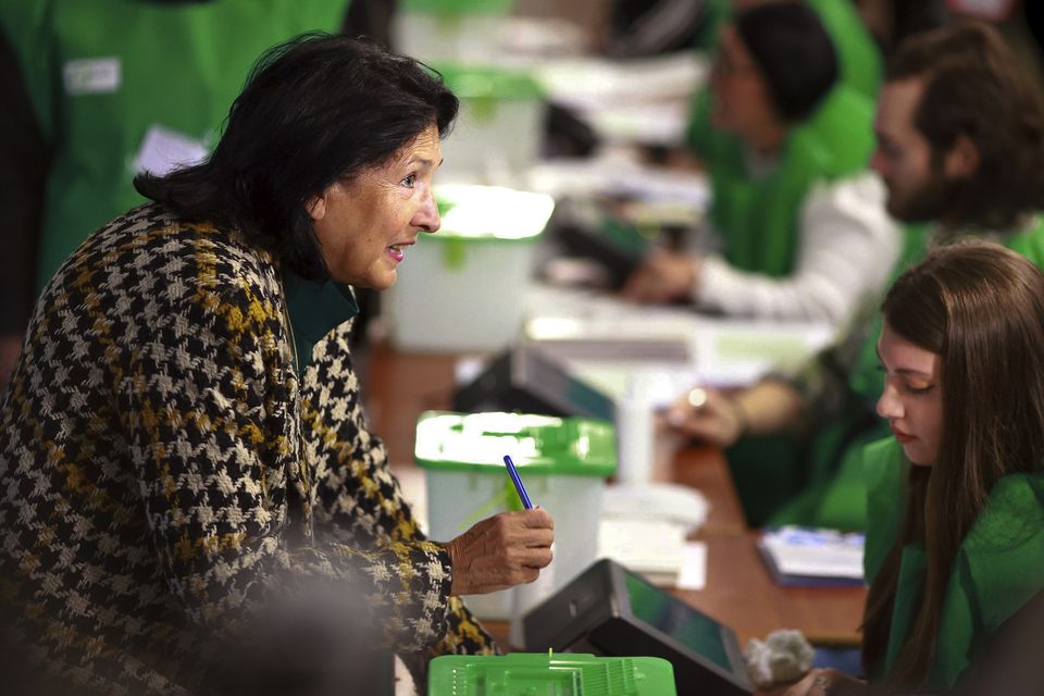 Georgian President Salome Zourabichvili gets her ballot at a polling station during the parliamentary election in Tbilisi, Georgia (Shakh Aivazov/AP)