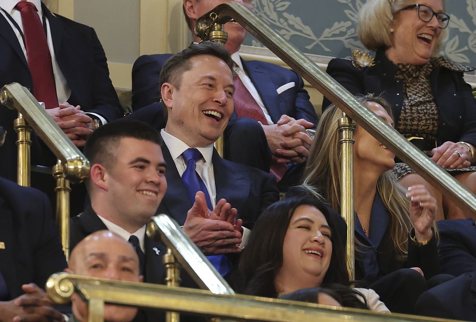 Elon Musk claps during Mr Trump’s address (Win McNamee/Pool Photo/AP)