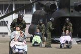 thumbnail: ALTERNATE CROP OF TOK890 OF MARCH 13, 2011 - Futaba Kosei Hospital patients are assisted by Japan Self Defense Force personnel as they disembark from a helicopter in the compound of Fukushima Gender Equality Centre in Nihonmatsu, Fukushima Prefecture, northeastern Japan, Sunday morning, March 13, 2011 after being evacuated from the hospital in Futaba town near the troubled Fukushima Dai-ichi nuclear complex. They might have been exposed to radiation while waiting for evacuation when an explosion of Unit 1 reactor of the complex blew off the top part of its walls on Saturday, one day after a strong earthquake and tsunami hit northeastern Japan. (AP Photo/The Yomiuri Shimbun, Daisuke Tomita)  JAPAN OUT, CREDIT MANDATORY