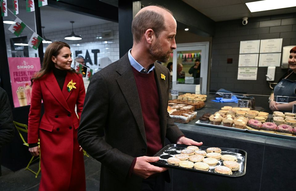 The royal couple distributed the cakes to well-wishers (Ben Stansall/PA)