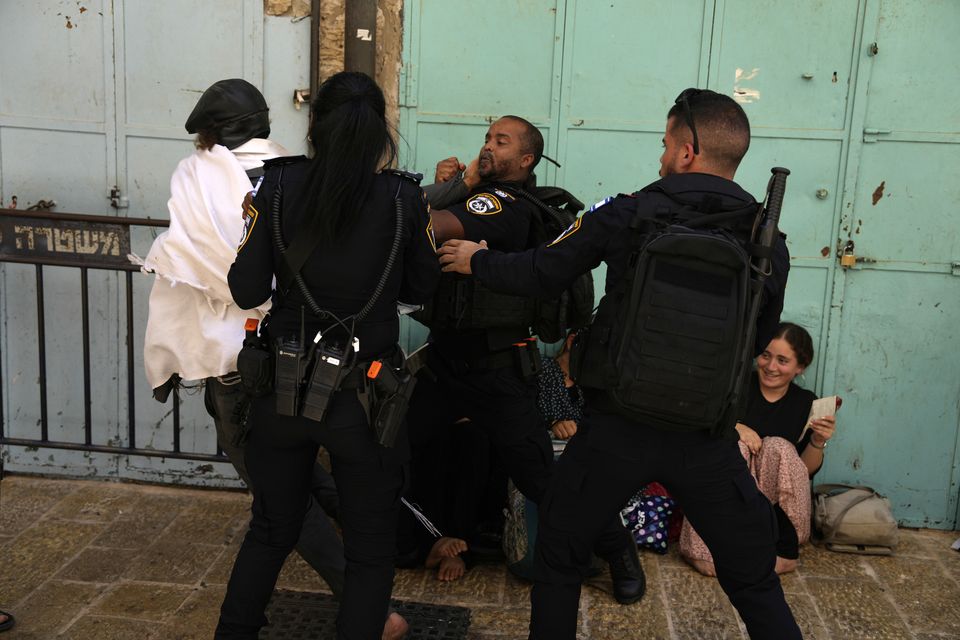 Israeli police prevent a Jewish worshipper from breaking through the police barrier to enter Jerusalem’s most sensitive holy site (Ohad Zwigenberg/AP)