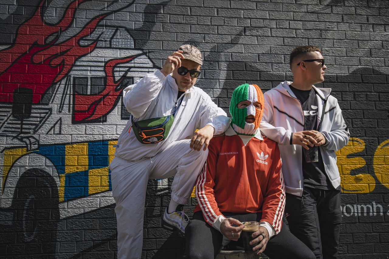 West Belfast: Irish language hip hop band Kneecap unveil new mural ...