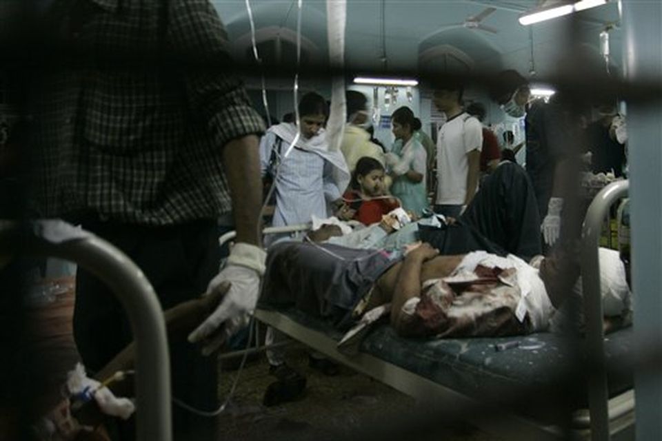 **  EDS NOTE GRAPHIC CONTENT  **  A victim of a gun attack lies on a hospital bed at the St. George's hospital in Mumbai, India, Wednesday, Nov. 26, 2008. Indian police say several people have been wounded when gunmen opened fire on at least seven places in Mumbai, including luxury hotels. A.N. Roy, a senior police officer, says police were battling the gunmen. (AP Photo/Rajanish Kakade)