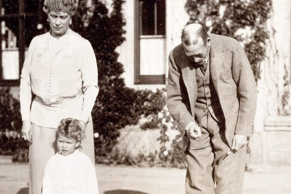 Princess Elizabeth with her grandparents King George V and Queen Mary; and Snip the King's Cairn terrier, 1928.