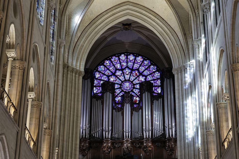 The western rose window with the organ pipes rising before it (Stephane de Sakutin, pool via AP)