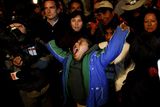 thumbnail: Marcelo Vilquinina, nephew of trapped miner Carlos Mamani Solis, yawns as he watches rescue operations on TV from the camp outside the San Jose mine near Copiapo, Chile, Wednesday Oct. 13, 2010. Thirty-three miners became trapped when the gold and copper mine collapsed on Aug. 5. Mamani was the fourth miner to be rescued. (AP Photo/Natacha Pisarenko)