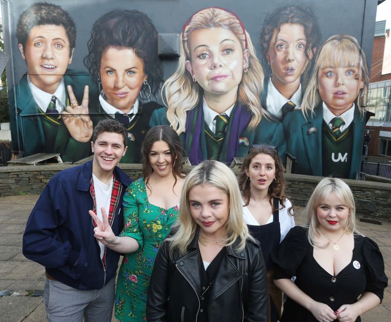 Derry Girls creator Lisa McGee, second from left, with cast members Dylan Llewellyn , Saoirse-Monica Jackson, Louisa Harland and Nicola Coughlan when they visited the 'Derry Girls' mural painted by UV Artists on the gable wall of Badger's Bar, Derry.  Picture by Lorcan Doherty  / Press Eye from 2018