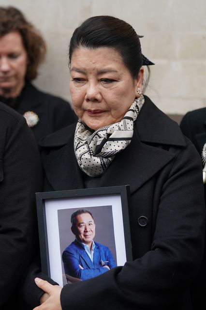 Aimon Srivaddhanaprabha holding a photo of her husband Khun Vichai (Joe Giddens/PA)