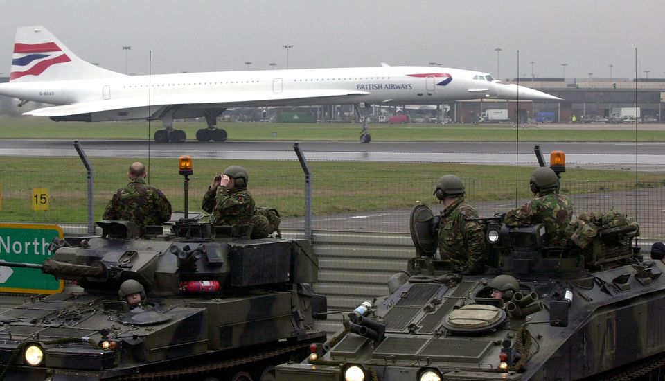 Troops look on as Concorde prepares to take off from Heathrow (Tim Ockenden/PA)