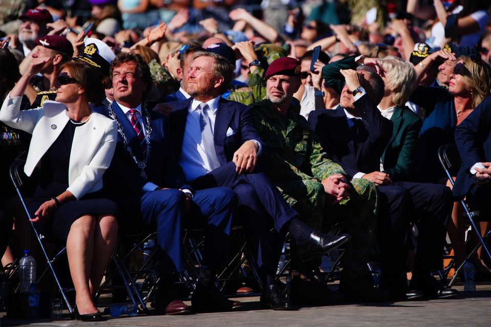 King Willem-Alexander of the Netherlands (front row, third from left) looks to the sky (Ben Birchall/PA)