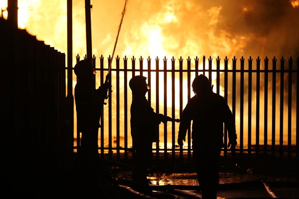 Press Eye - Belfast - Northern Ireland - 11th July  2018 

General view fire officers cooling down a building at the  Hope Street bonfire at Sandy Row in South Belfast.

It comes after the PSNI issued a notice informing the public that paramilitaries intend to orchestrate serious disorder against police officers on the Eleventh night.

Photo by Kelvin Boyes / Press Eye.