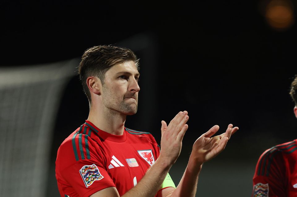 Ben Davies (left) and Neco Williams (right) appear downcast after Wales surrendered a two-goal lead to draw 2-2 in Iceland (Arni Torfason/AP)