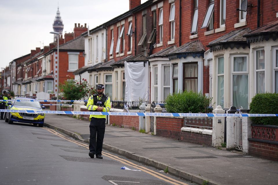 Firefighters and police officers were called to the address in Peter Street at 2.39am on Wednesday to reports of a blaze with people inside (Peter Byrne/PA)