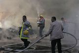 thumbnail: United Nations workers and Palestinian firefighters work to try and put out a fire and save bags of food aid at the United Nations headquarters after it was hit in Israeli bombardment in Gaza City, Thursday, Jan. 15, 2009. Israeli forces shelled the United Nations headquarters in the Gaza Strip on Thursday, setting the compound on fire as U.N. chief Ban Ki-moon was in the area on a mission to end Israel's devastating offensive against the territory's Hamas rulers. Ban expressed "outrage" over the incident.(AP Photo/Hatem Moussa)
