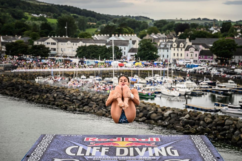 Paty Valente of Brazil dives from the 21 metre platform during the second competition day of the fourth stop of the 2024 Red Bull Cliff Diving World Series at Ballycastle Harbour, Causeway Coast, Northern Ireland on July 19, 2024.