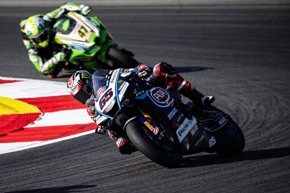 Jonathan Rea aims to fend off the challenge of his opponent during the World Superbike event at Portimao