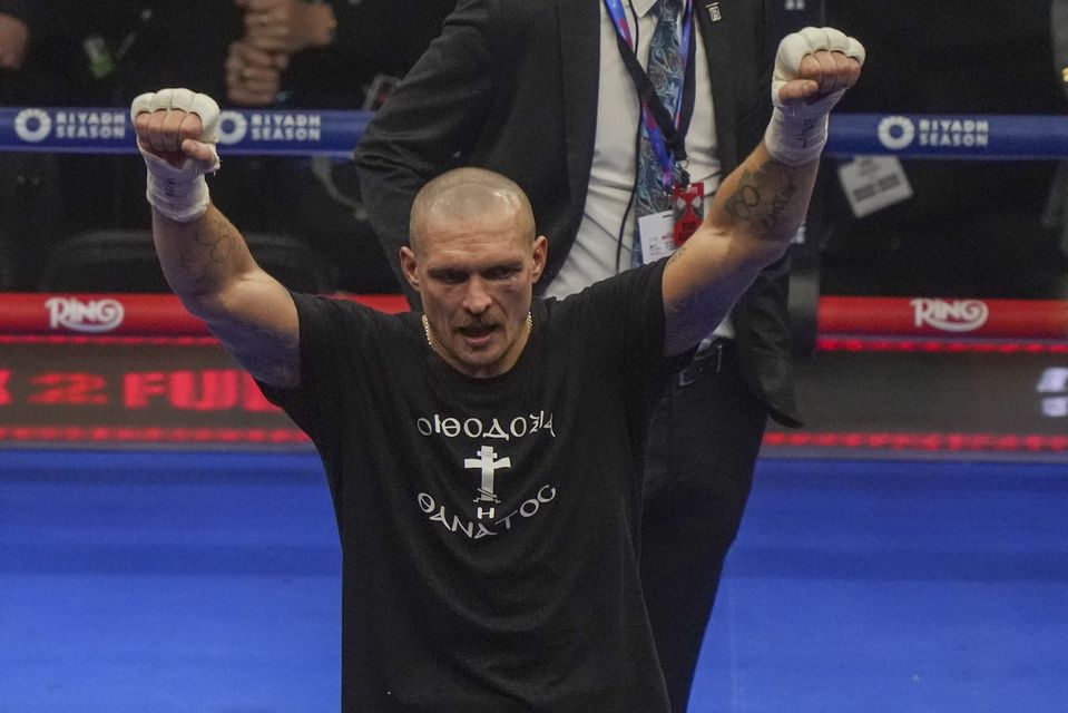 Oleksandr Usyk celebrates after retaining his titles (Frank Augstein/AP)