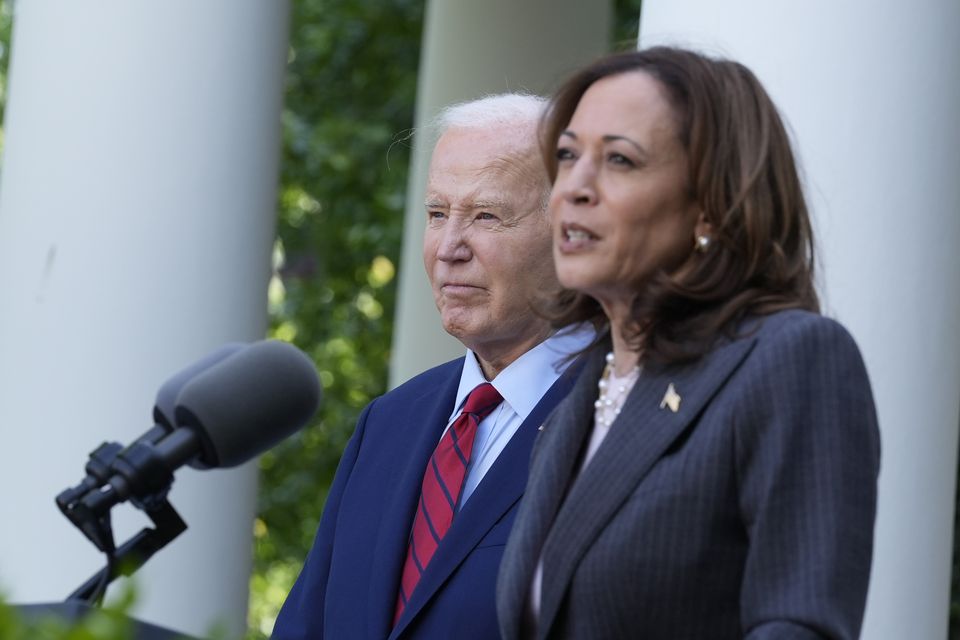 President Joe Biden listens as Vice President Kamala Harris speaks in the Rose Garden of the White House in Washington (Susan Walsh/AP)