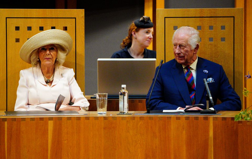 The King and Queen sit in the Senedd chamber, where Charles touched on his pride in seeing his son, the current Prince of Wales, continue his relationship with the country (Ben Birchall/PA)