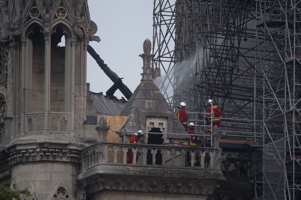 Firefighters in the remains of the Notre Dame cathedral in 2019 (Victoria Jones/PA)