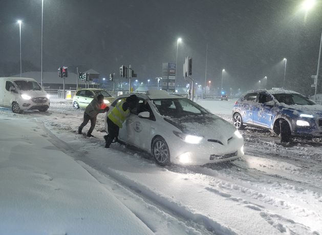 Heavy snow causes travel disruption across UK as amber warnings remain