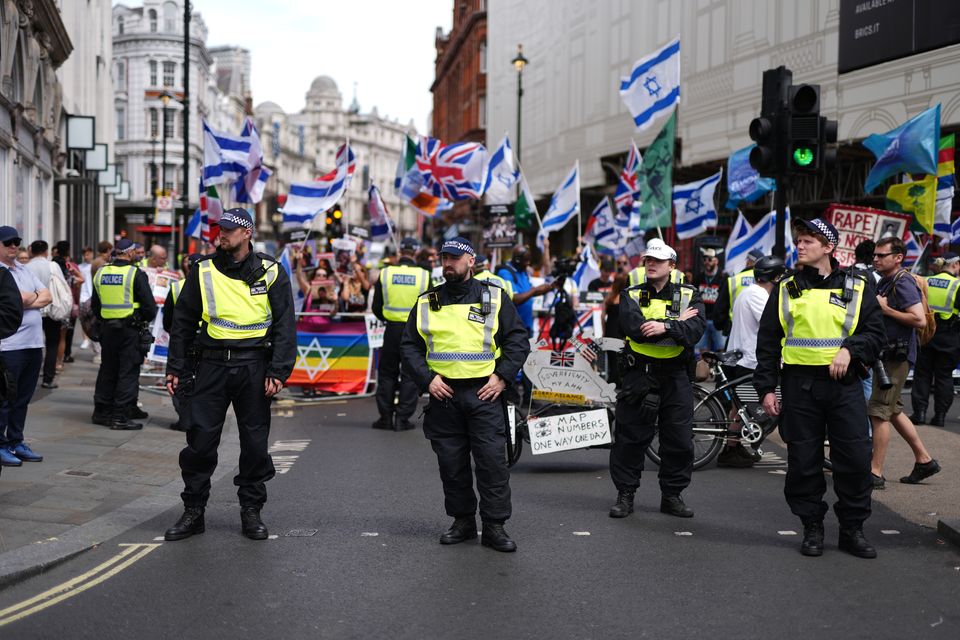 A heavy police presence as people take part in the Enough is Enough protest in Piccadilly Circus (Jordan Pettitt/PA)