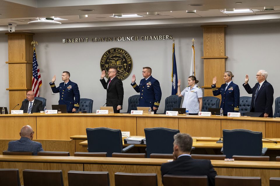 Coast guard members of the investigative board for the Titan marine board formal hearing take an oath in the Charleston County Council Chambers at the start pf the hearing (Mic Smith/AP)