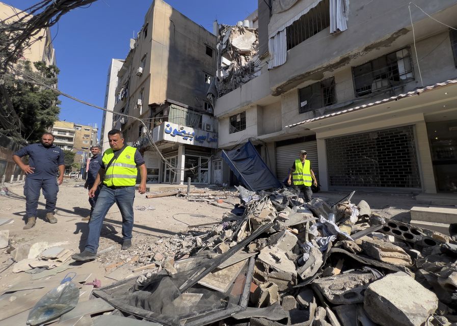 An Israeli air strike hit a suburb of Beirut on Tuesday, with Tel Aviv saying it had targeted a Hezbollah commander responsible for a rocket attack that killed 12 children (AP)