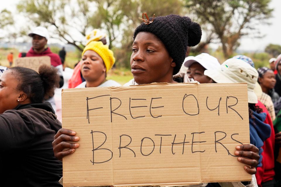 Relatives and friends protest near the gold mine in Stilfontein, South Africa, where illegal miners are trapped (Denis Farrell/AP)