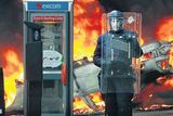 thumbnail: A garda stands by a burning car in Nassau Street during riots following the 'Love Ulster' march in Dublin in February 2006