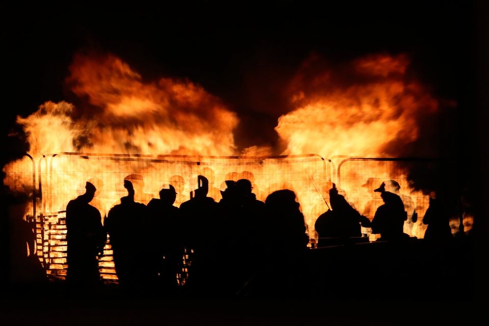 People attend an 11th night Bonfire in the Sandy Row area of Belfast.  Pic: Niall Carson/PA Wire