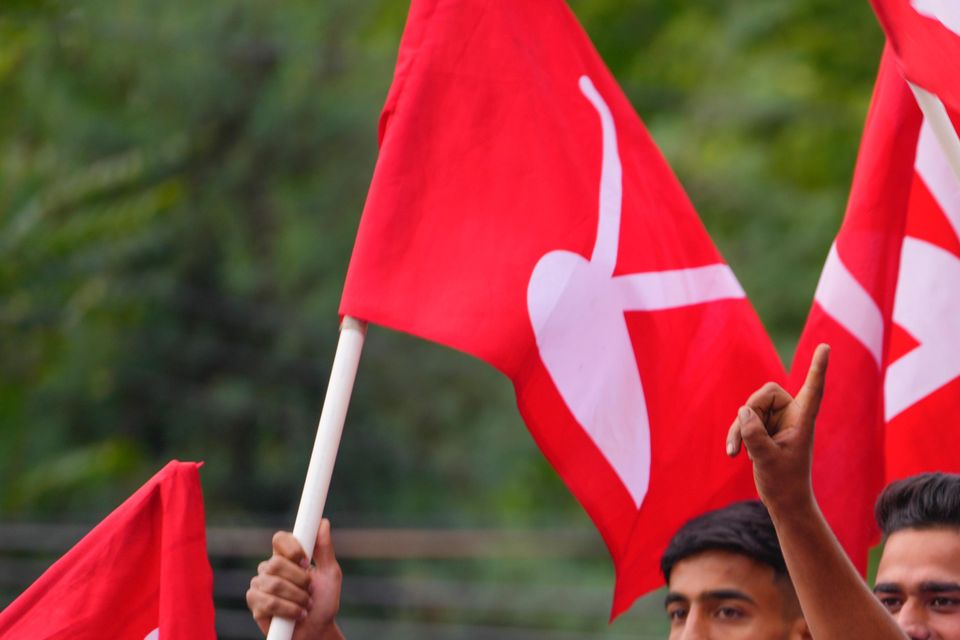 Supporters of the National Conference party in Srinagar shout slogans as they celebrate early leads in the election for a local government in Indian-controlled Kashmir (Dar Yasin/AP)