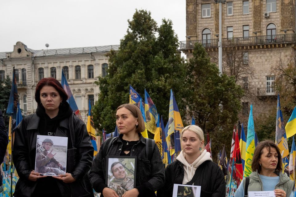 People held photos of their relatives during a nationwide minute’s silence in memory of fallen soldiers (Efrem Lukatsky/AP)