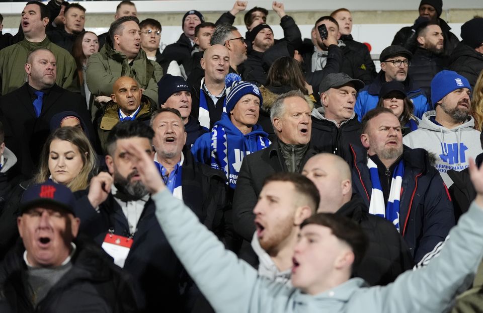 Birmingham’s American chairman Tom Wagner (centre, blue club bobble hat and scarf) was in the away end (Nick Potts/PA)