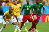 thumbnail: BRASILIA, BRAZIL - JUNE 23: Maxim Choupo-Moting of Cameroon controls the ball against Dani Alves of Brazil during the 2014 FIFA World Cup Brazil Group A match between Cameroon and Brazil at Estadio Nacional on June 23, 2014 in Brasilia, Brazil.  (Photo by Clive Brunskill/Getty Images)